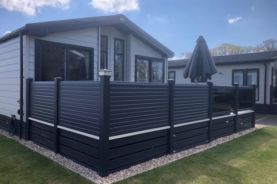 Holiday home with Liniar decking and grey balustrade fencing 