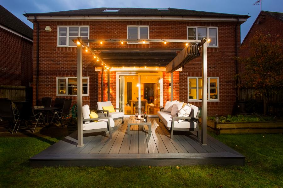 Back garden of a redbrick deatched home with a sliding patio door leading omto a Liniar PVCu SwitchBoard Ultra decking area