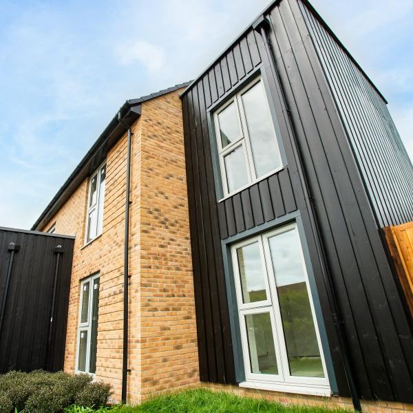 Ground view of house with black cladding and Resurgence windows