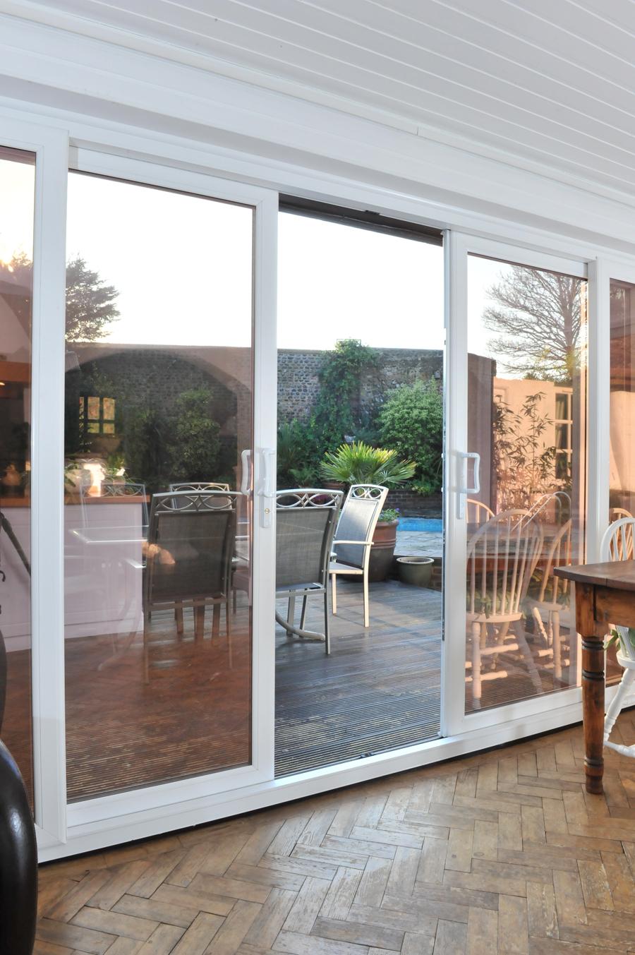 White Liniar patio door opened onto a wooden decked area