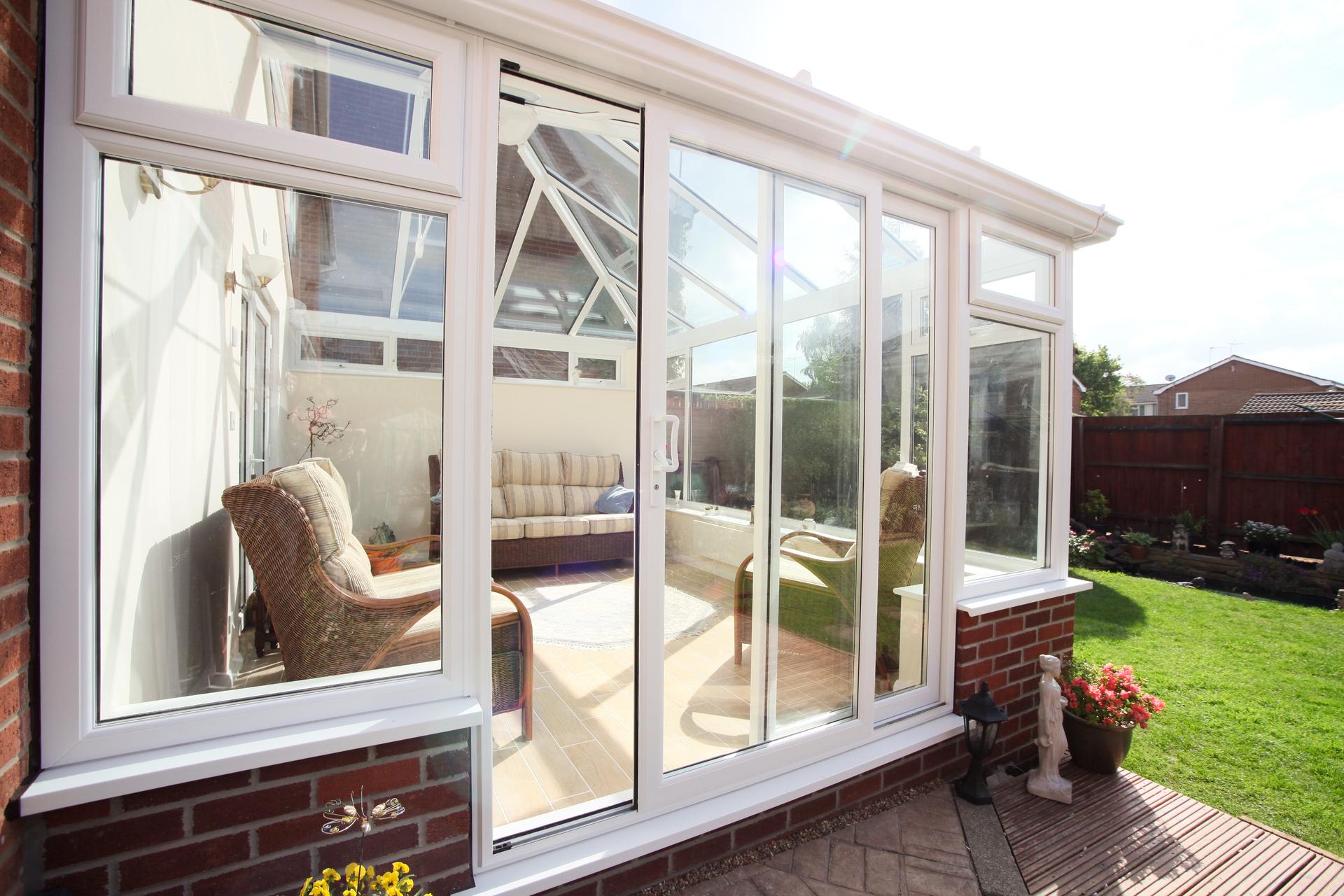 White conservatory with white Liniar Patio Plus doors