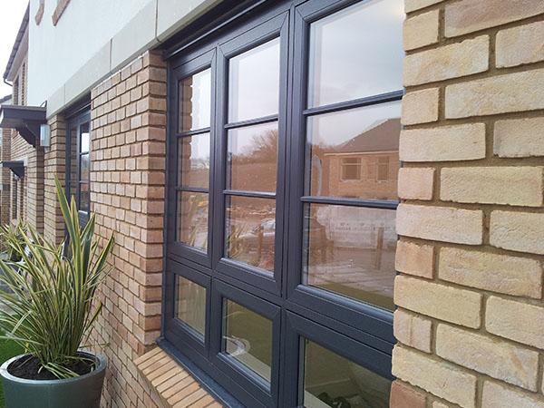 Grey Liniar flush sash window on a new build house 