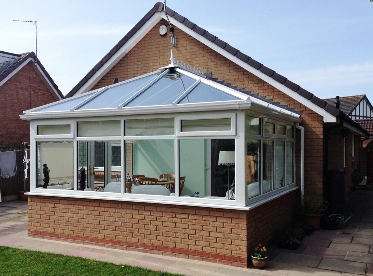 Bungalow featuring a white, Edwardian Liniar conservatory with casement windows